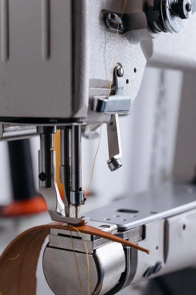 Industrial sewing machine stitching leather
